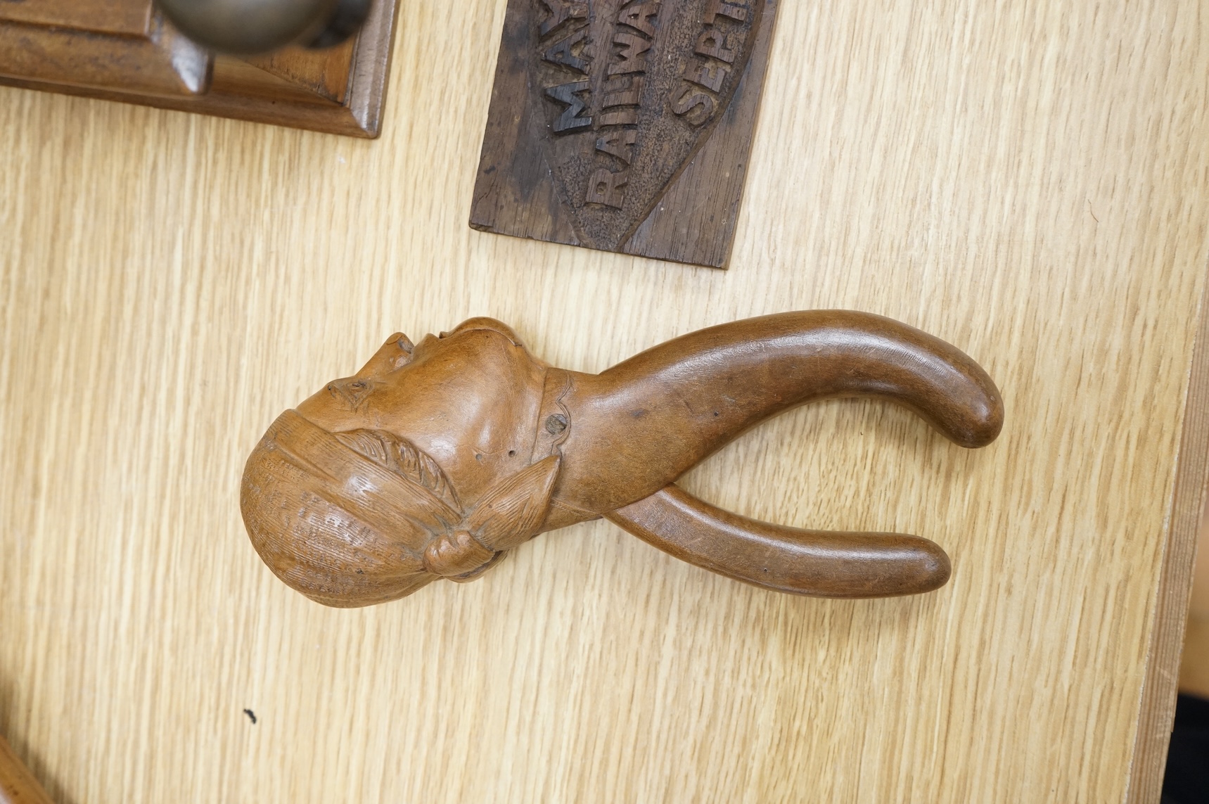 A coffee grinder, a figural nut cracker, two walking sticks, one mother of pearl inlaid and a railway sign